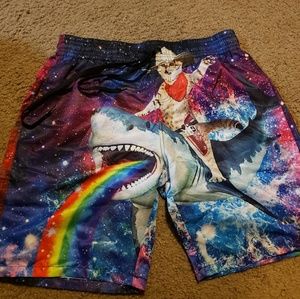 Funny cat riding shark puking rainbow swim trunks